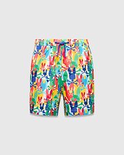 Kids Tanner Swim Trunk with a vibrant all-over print of colorful Psycho Bunny skull logos, crossbones, and surfboards on a white background, featuring a royal blue drawstring.