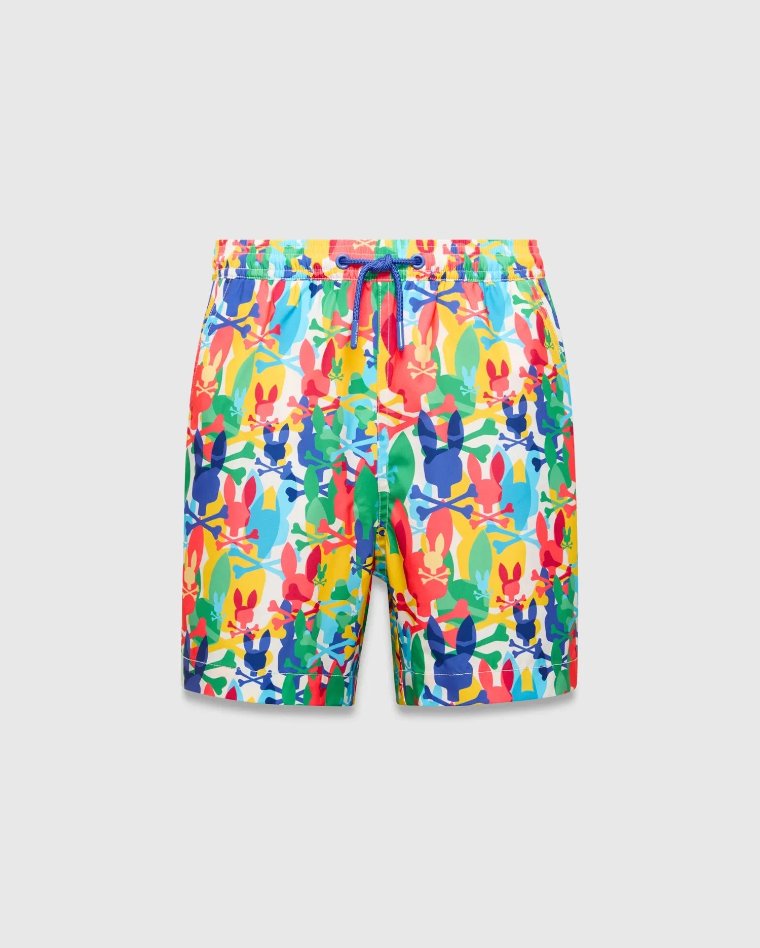 Kids Tanner Swim Trunk with a vibrant all-over print of colorful Psycho Bunny skull logos, crossbones, and surfboards on a white background, featuring a royal blue drawstring.