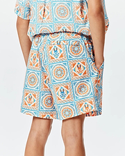 Kids Frank Swim Trunk in a relaxed fit, featuring a vibrant white, orange, and blue mosaic tile pattern with integrated Psycho Bunny skull logos, elastic waistband, and side pockets.