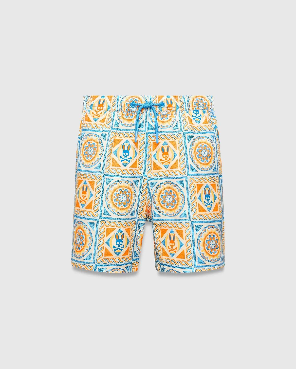Kids Frank Swim Trunk with a vibrant all-over tile pattern in cream, orange, and blue, featuring repeating Psycho Bunny skull logos and mandala designs, finished with a bright blue drawstring for a relaxed fit.