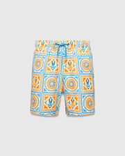 Kids Frank Swim Trunk with a vibrant all-over tile pattern in cream, orange, and blue, featuring repeating Psycho Bunny skull logos and mandala designs, finished with a bright blue drawstring for a relaxed fit.