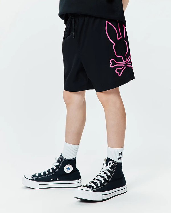 Kids Duncan Bunny Print Swim Trunk in black, featuring a large neon pink graphic Psycho Bunny skull logo on the left leg, with a relaxed fit and smooth swim fabric.