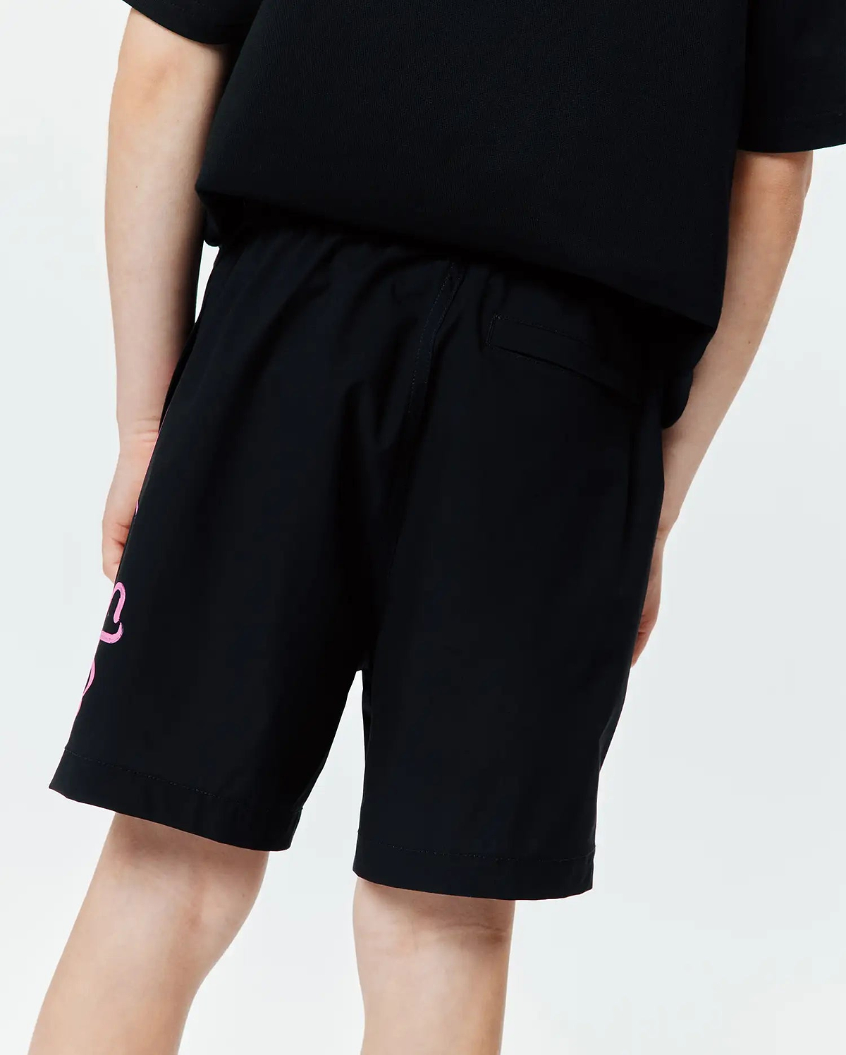 Kids Duncan Bunny Print Swim Trunk, black, featuring a large pink stylized bunny graphic on the left leg, a relaxed fit, and smooth quick-dry swim fabric.