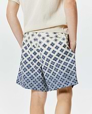 Kids Tobias Swim Trunk, cream with a bold, all-over navy blue geometric pattern featuring the iconic Psycho Bunny skull logo, offering a relaxed fit in smooth, quick-dry fabric.