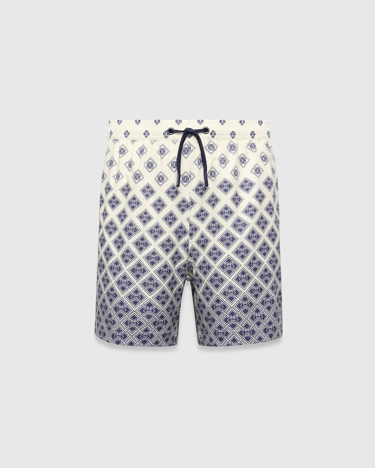 Kids Tobias Swim Trunk in cream with a navy blue diamond grid pattern featuring repeated Psycho Bunny skull logos, a relaxed fit, and a navy drawstring. The pattern intensifies towards the hem.