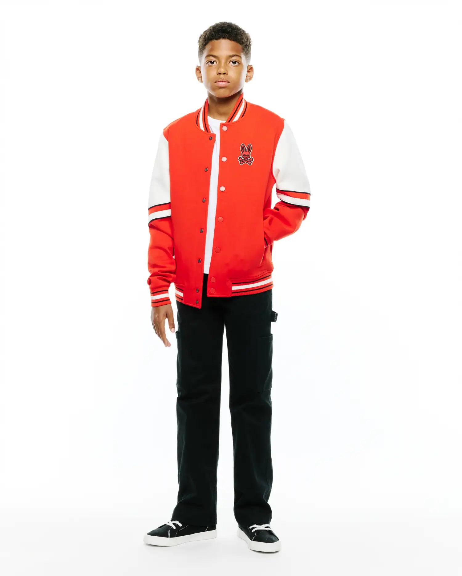 Kids Joey Knit Bomber jacket in vibrant red with white sleeves, featuring a classic varsity design, snap buttons, striped ribbed trim, and an embroidered Psycho Bunny skull logo on the left chest.
