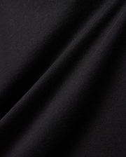 Kids Gordley Mix Media Jacket, a premium Psycho Bunny piece in deep black, showcasing a luxurious, soft-touch jersey knit fabric with subtle texture and elegant draping folds, hinting at refined streetwear style.