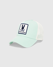 Kids Adamo Bunny Trucker Cap, a mint green cotton twill cap with a white mesh back. Features a prominent, embroidered navy blue and white Psycho Bunny skull logo patch on the front crown.