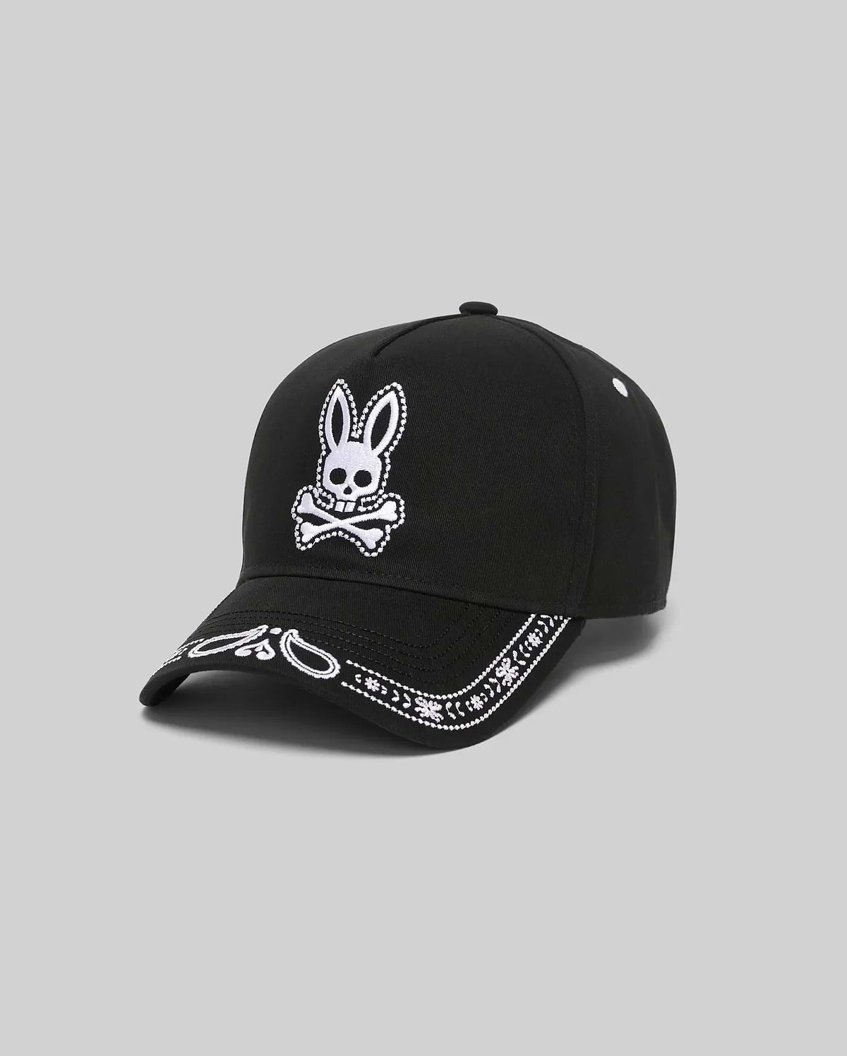 Black Kids Luke Trucker Cap with a large white embroidered Psycho Bunny skull logo on the front and a white embroidered bandana pattern along the brim.