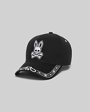 Black Kids Luke Trucker Cap with a large white embroidered Psycho Bunny skull logo on the front and a white embroidered bandana pattern along the brim.