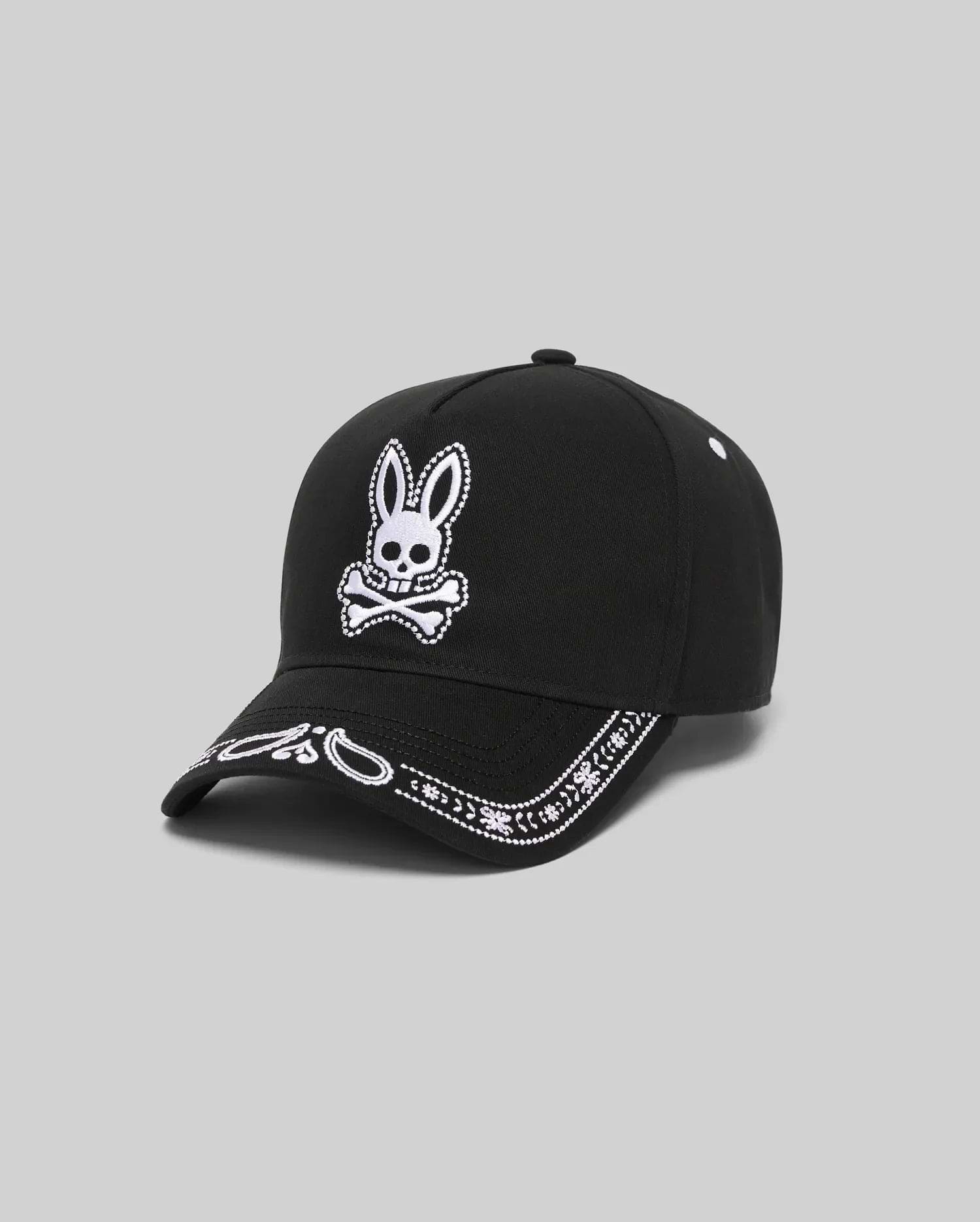 Black Kids Luke Trucker Cap with a large white embroidered Psycho Bunny skull logo on the front and a white embroidered bandana pattern along the brim.