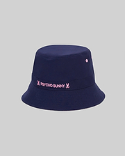 Kids Luke Reversible Bucket Hat in navy, featuring a prominent embroidered pink Psycho Bunny text logo with bunny skull icons on the front band and matching pink ventilation eyelets.