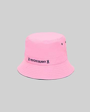 Kids Luke Reversible Bucket Hat in bright pink with dark blue embroidered Psycho Bunny text and skull logo on the band, featuring ventilation eyelets and a reversible design.