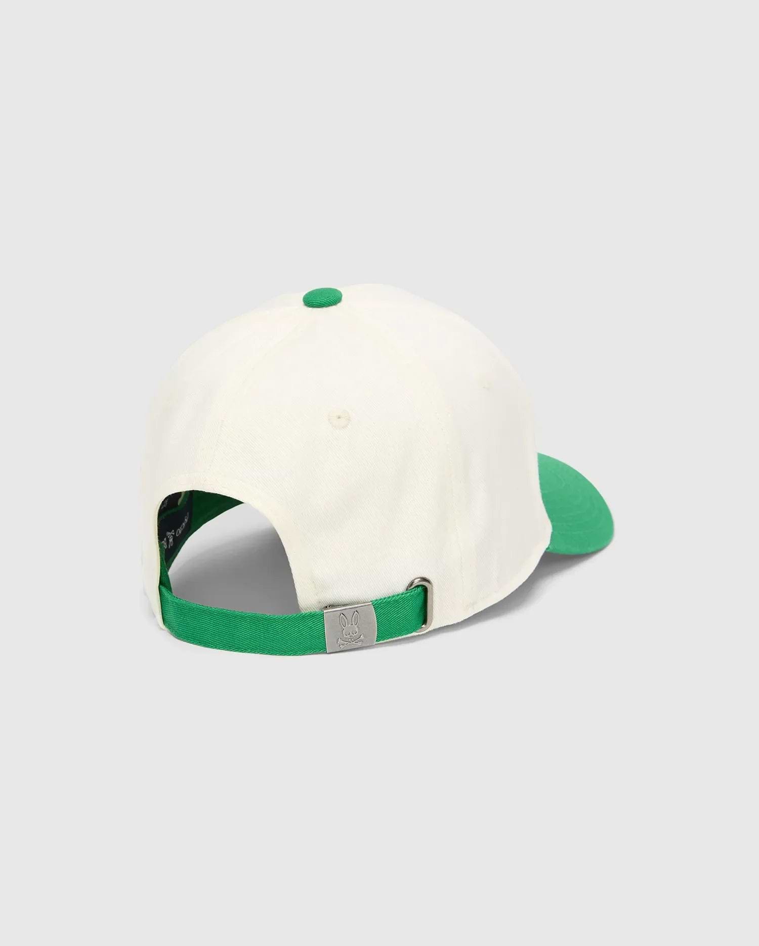 Kids Craig Baseball Cap in cream cotton twill with a vibrant green brim, top button, and adjustable strap featuring an embossed Psycho Bunny skull logo on the silver-tone metal buckle.