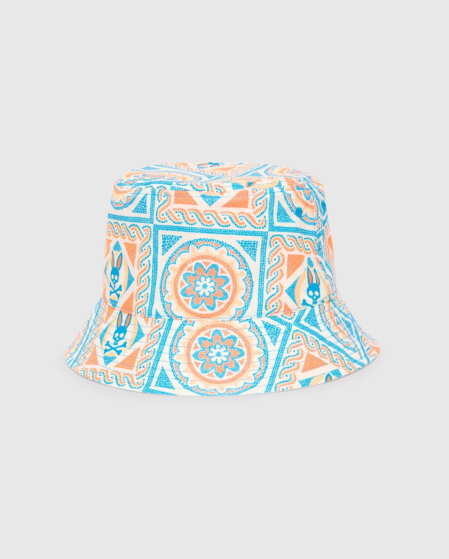 Kids Frank Reversible Bucket Hat featuring a vibrant cream, blue, and orange mosaic-style geometric and floral pattern with integrated Psycho Bunny skull logos.
