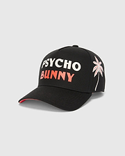 Black Kids Brad Trucker Cap with bold white PSYCHO and coral BUNNY text on the front, featuring an embroidered white and coral palm tree graphic on the right side, and a coral underside brim.