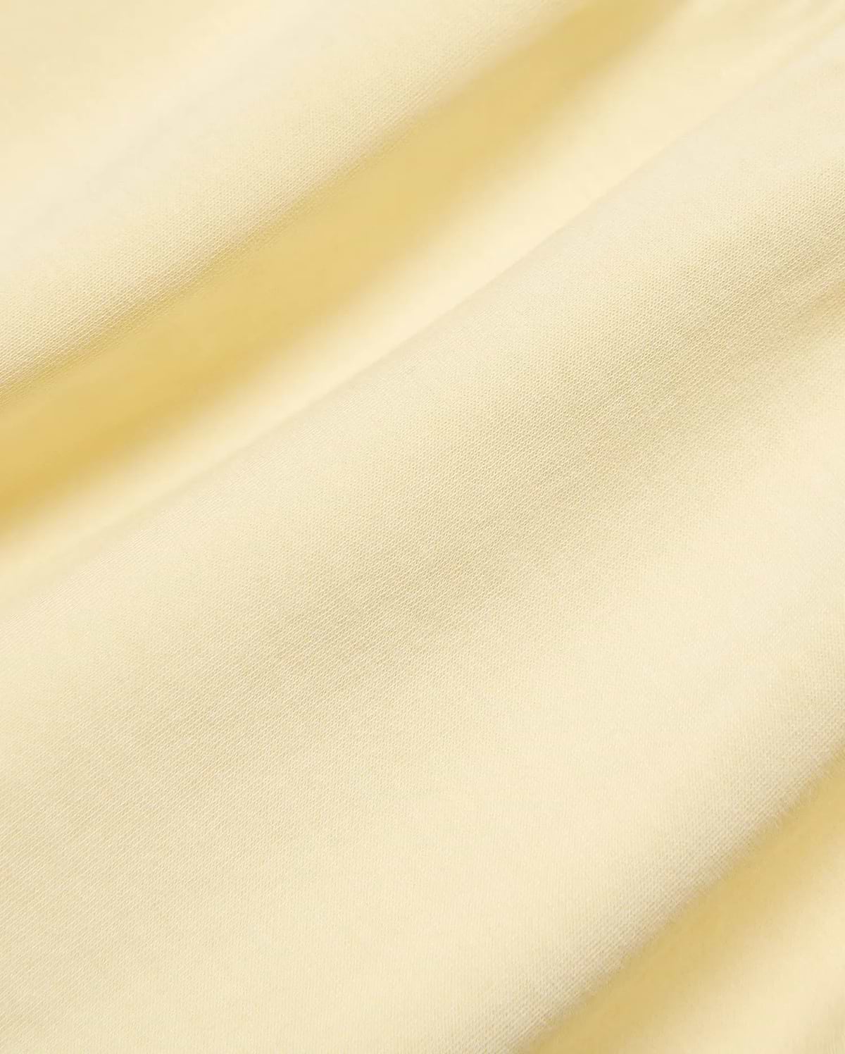 Kids Girl's Penelope Dress, crafted from premium soft pale yellow jersey knit fabric, showcasing its subtle texture, elegant draping, and refined Psycho Bunny quality. (6)
