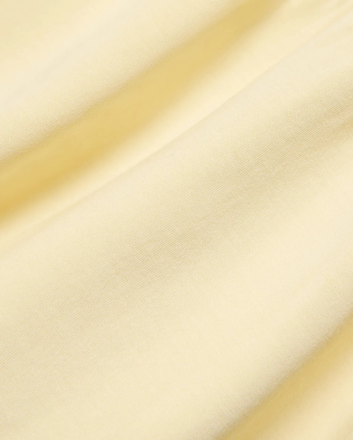 Kids Girl's Penelope Dress, crafted from premium soft pale yellow jersey knit fabric, showcasing its subtle texture, elegant draping, and refined Psycho Bunny quality. (6)