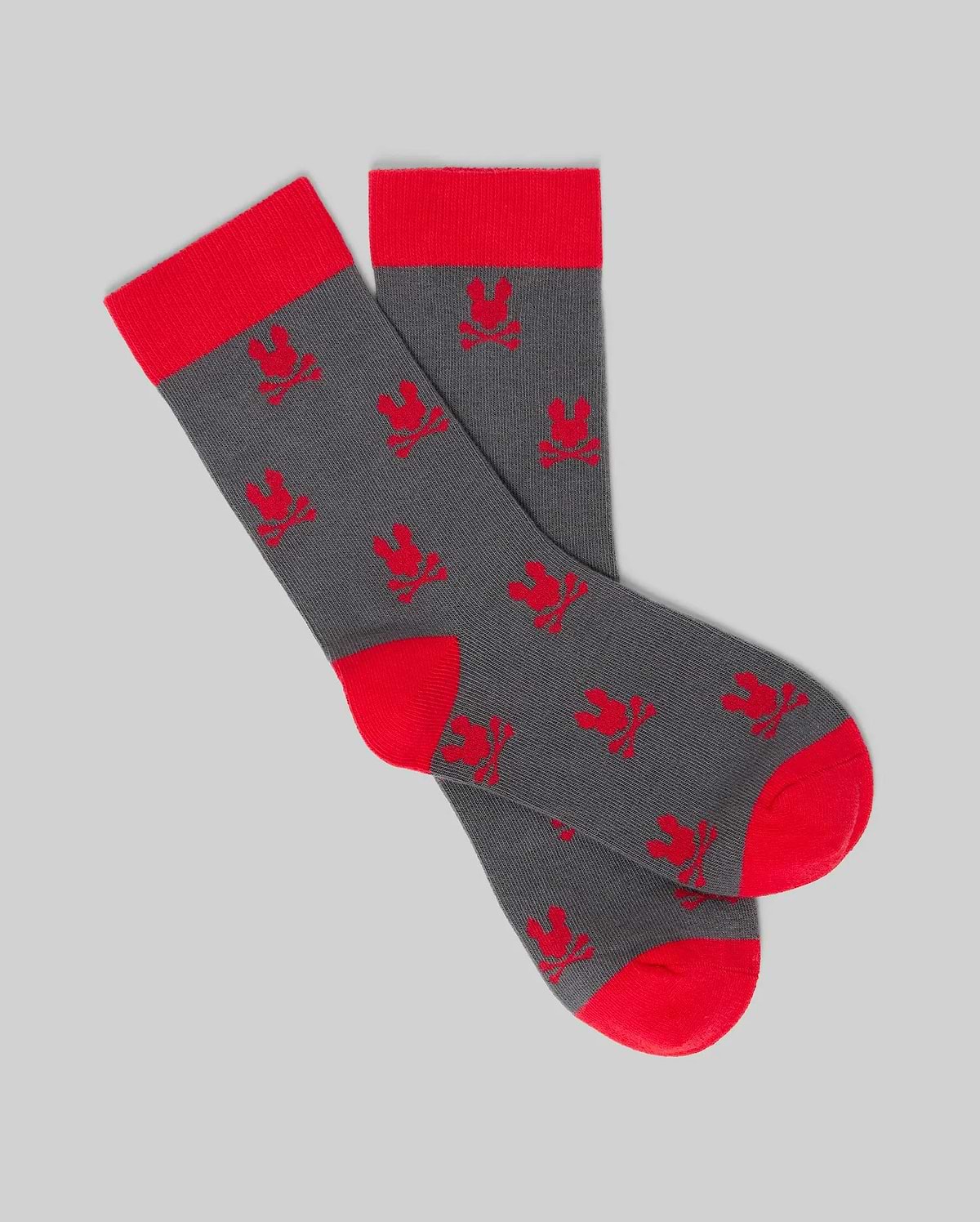 Psycho Bunny KIDS 2 PACK ALL OVER BUNNY DRESS SOCK - KO2200003: Gray Pima cotton socks with red heels, toes, and cuffs, featuring repeated red bunny patterns on a plain gray background. (3)