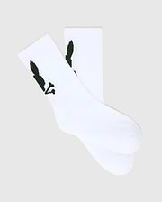 Kids 3 Pack Sport Socks in crisp white, crafted from a smooth knit fabric, featuring the iconic dark green Psycho Bunny skull logo prominently on the ankle cuff.