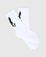 Kids 3 Pack Sport Socks in crisp white, crafted from a smooth knit fabric, featuring the iconic dark green Psycho Bunny skull logo prominently on the ankle cuff.