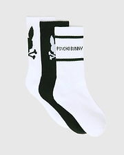 KIDS 3 PACK SPORT SOCKS in white and black, featuring large Psycho Bunny skull logos on two pairs and Psycho Bunny text with black stripes on one white pair, crafted from a smooth knit fabric.