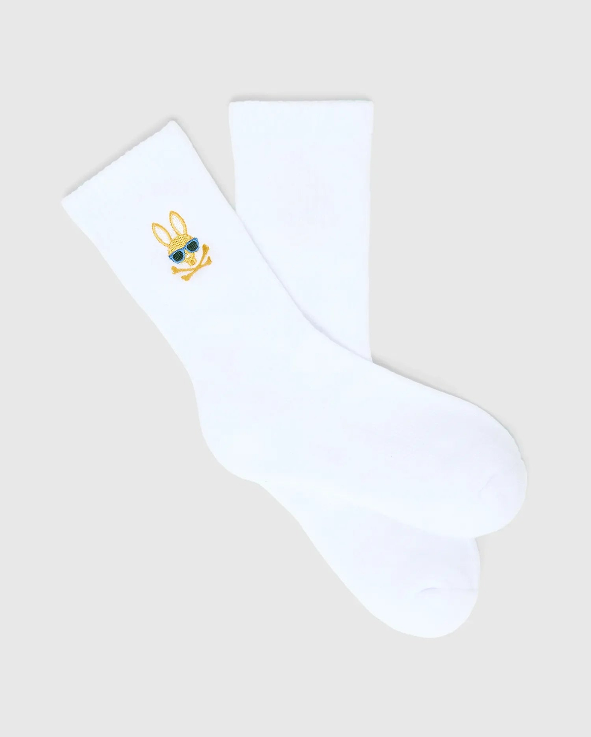 Kids Sunny 3 Pack Sport Socks: White smooth knit sport socks featuring a small, embroidered gold and blue Psycho Bunny skull logo with sunglasses on the ankle cuff. (4)