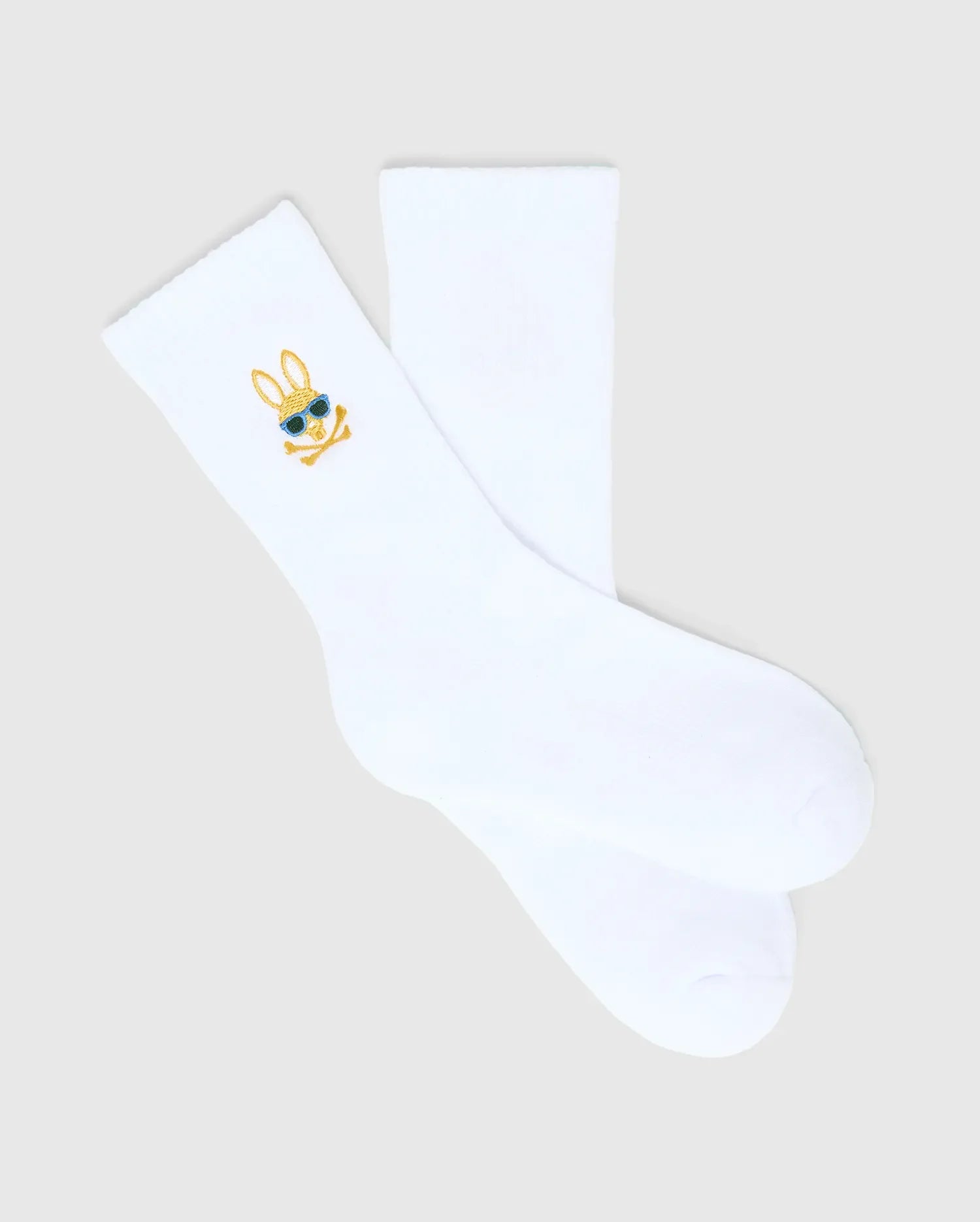Kids Sunny 3 Pack Sport Socks: White smooth knit sport socks featuring a small, embroidered gold and blue Psycho Bunny skull logo with sunglasses on the ankle cuff. (4)