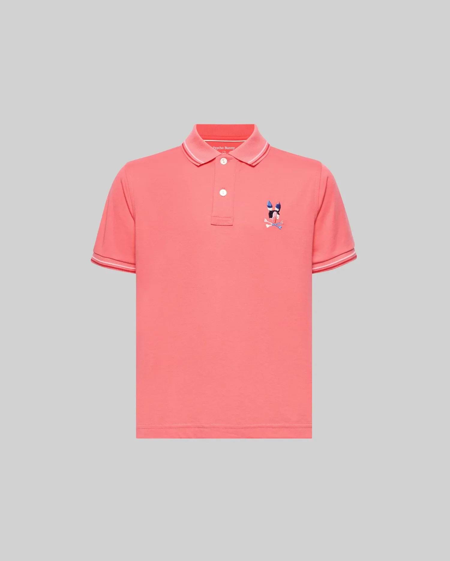 Kids Ara Pique Polo in coral pink, featuring a classic fit, pique knit fabric, white two-button placket, ribbed collar and cuffs with white tipping, and a small embroidered multi-color Psycho Bunny skull logo on the left chest.