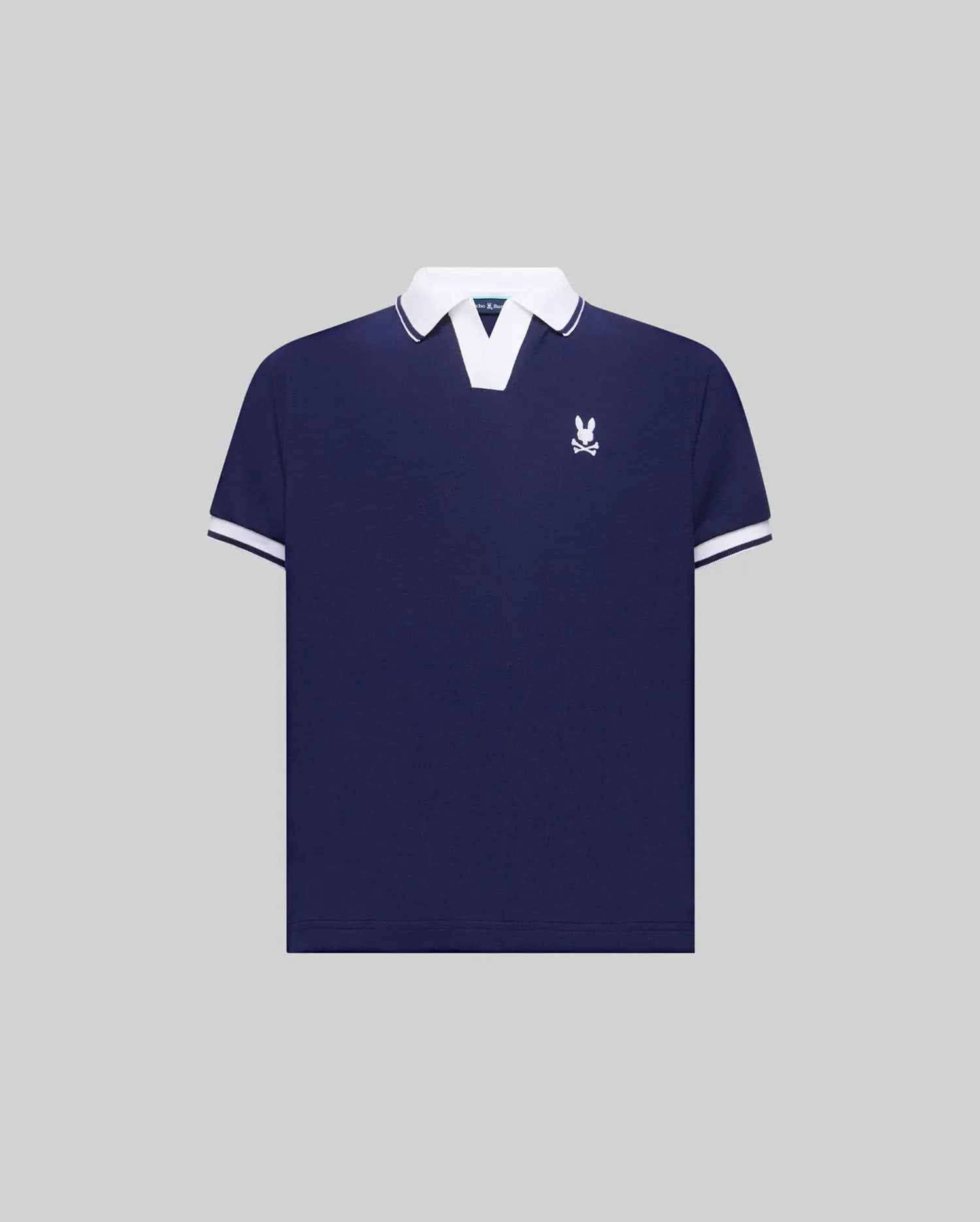 Kids Christiano Pique Polo in navy blue with a classic fit, featuring a white V-neck collar, white striped cuffs, and a small embroidered white Psycho Bunny skull logo on the left chest.