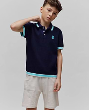 Kids Dax Knit Polo in navy, featuring a classic fit, fine knit texture, light blue and white striped collar, cuffs, and hem, with a small embroidered Psycho Bunny skull logo on the left chest.