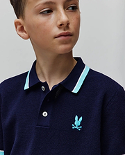 Kids Dax Knit Polo in navy, featuring a classic fit, light blue and white striped collar, white buttons, and an embroidered light blue Psycho Bunny skull logo on the left chest.
