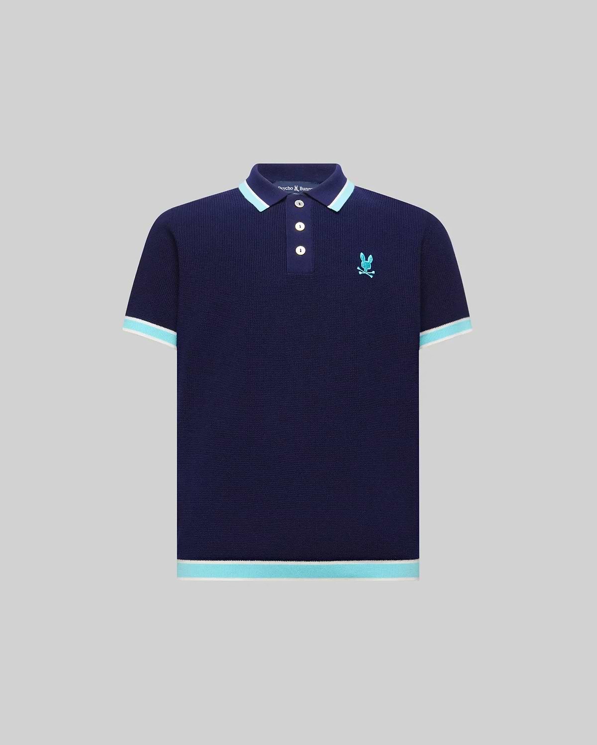 Kids Dax Knit Polo in navy, featuring a classic fit, knit texture, and a small embroidered light blue Psycho Bunny skull logo on the left chest. It has light blue and white striped collar, cuffs, and hem.