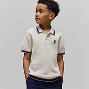 Kids Dax Knit Polo, cream waffle knit with navy and pink striped tipping on collar, cuffs, and hem, featuring a small embroidered black Psycho Bunny skull logo on the left chest.