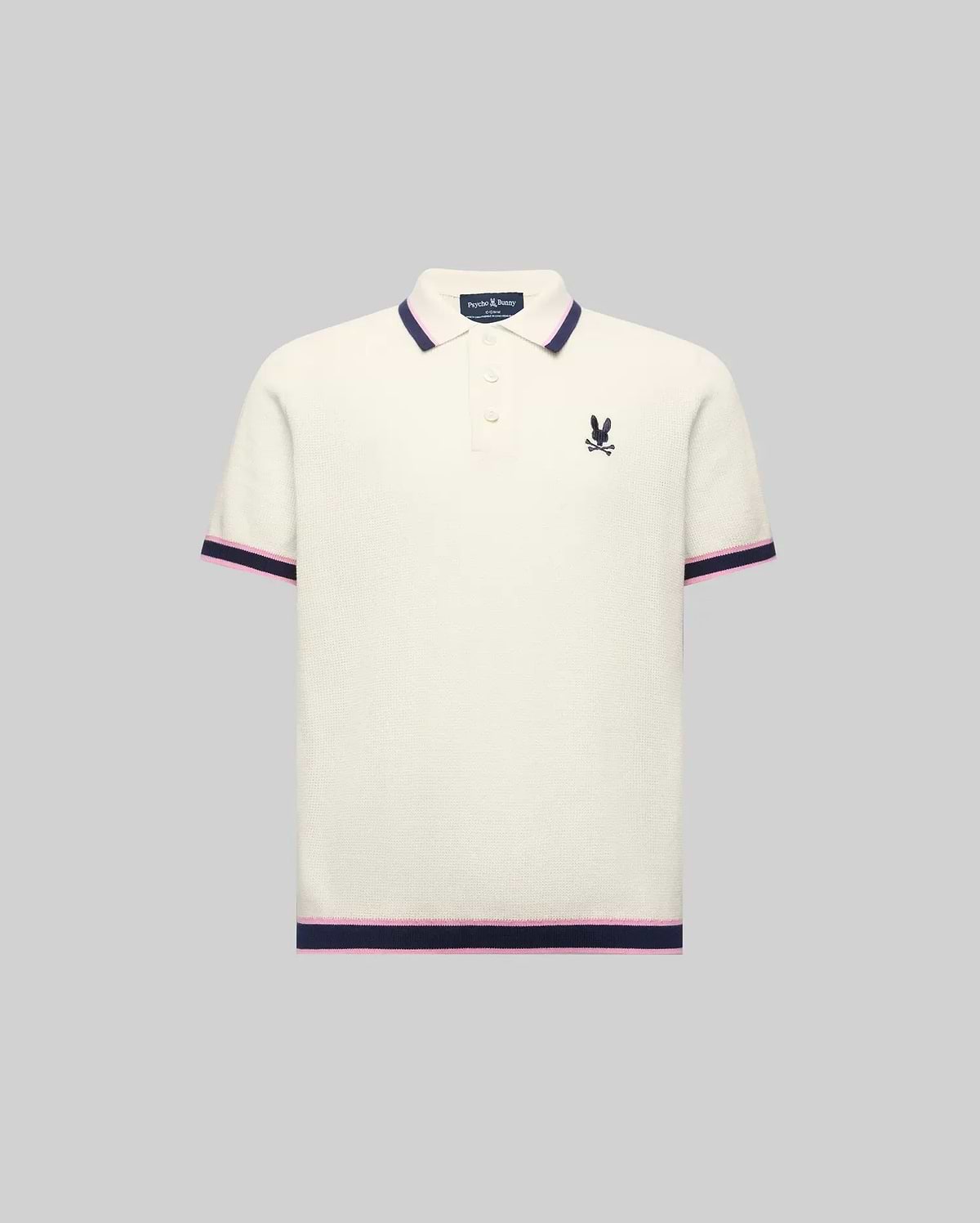 Kids Dax Knit Polo in cream, featuring a classic fit, fine knit texture, navy and pink striped collar, cuffs, and hem, with a small embroidered navy Psycho Bunny logo on the left chest.