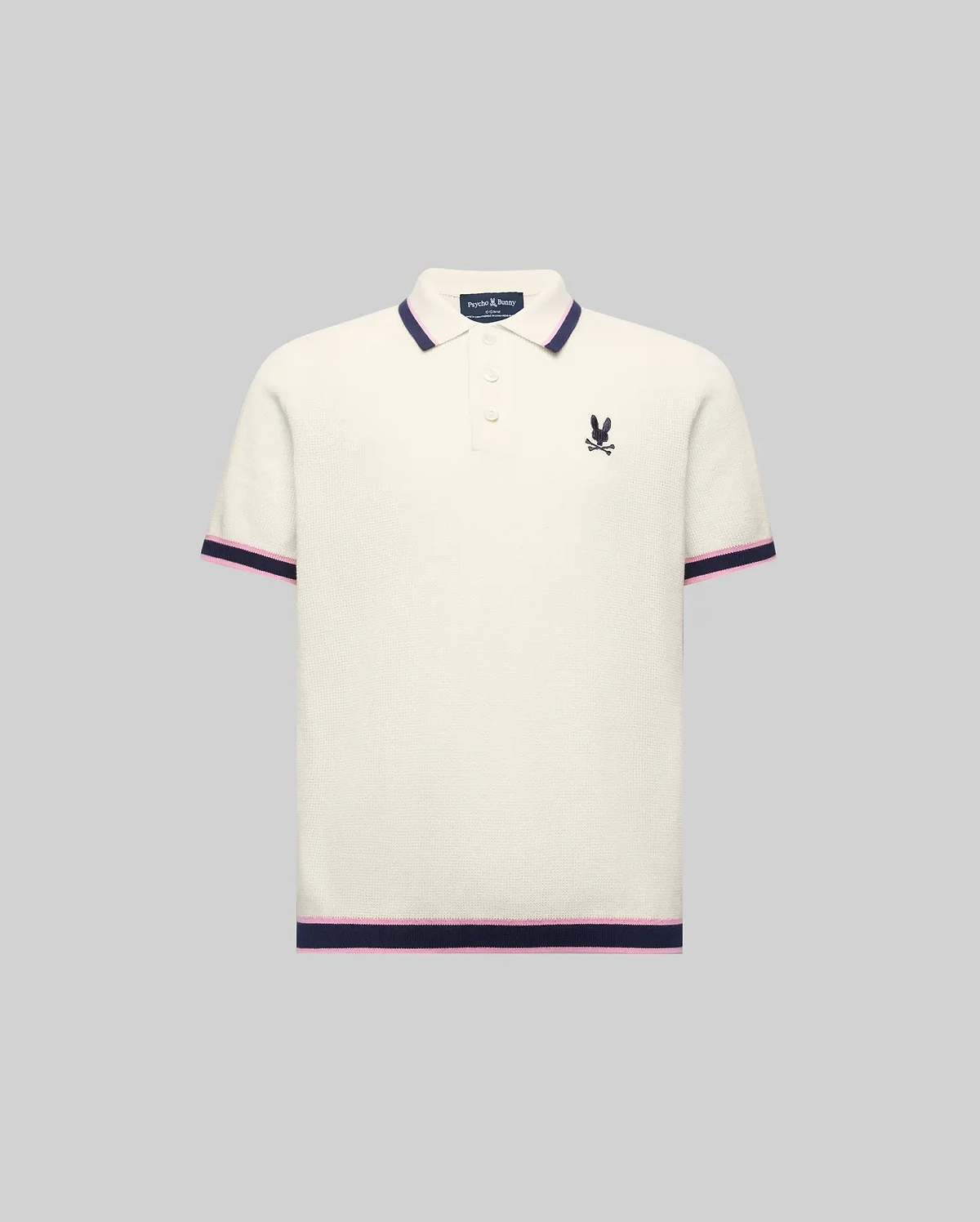 Kids Dax Knit Polo in cream, featuring a classic fit, fine knit texture, navy and pink striped collar, cuffs, and hem, with a small embroidered navy Psycho Bunny logo on the left chest.