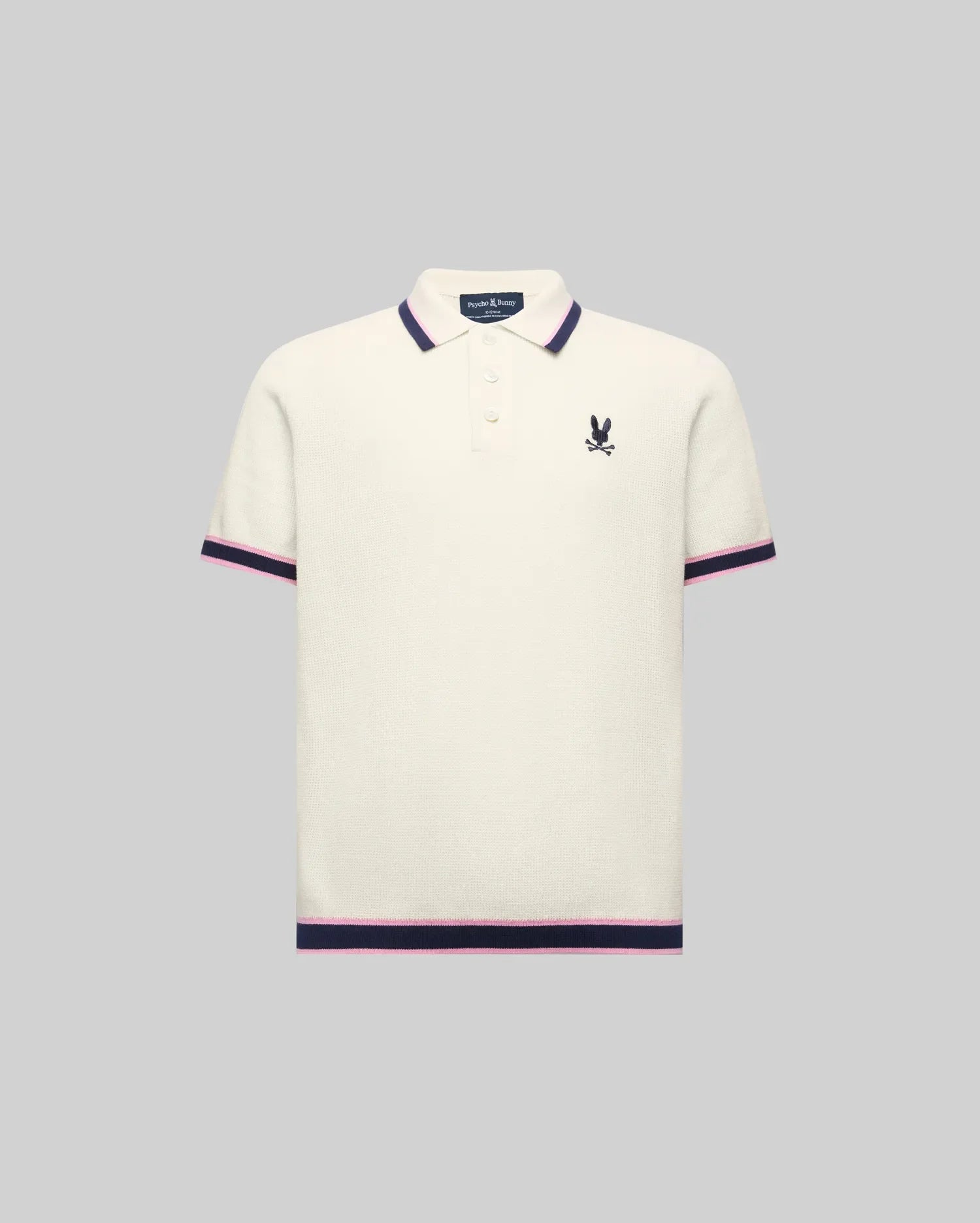 Kids Dax Knit Polo in cream, featuring a classic fit, fine knit texture, navy and pink striped collar, cuffs, and hem, with a small embroidered navy Psycho Bunny logo on the left chest.