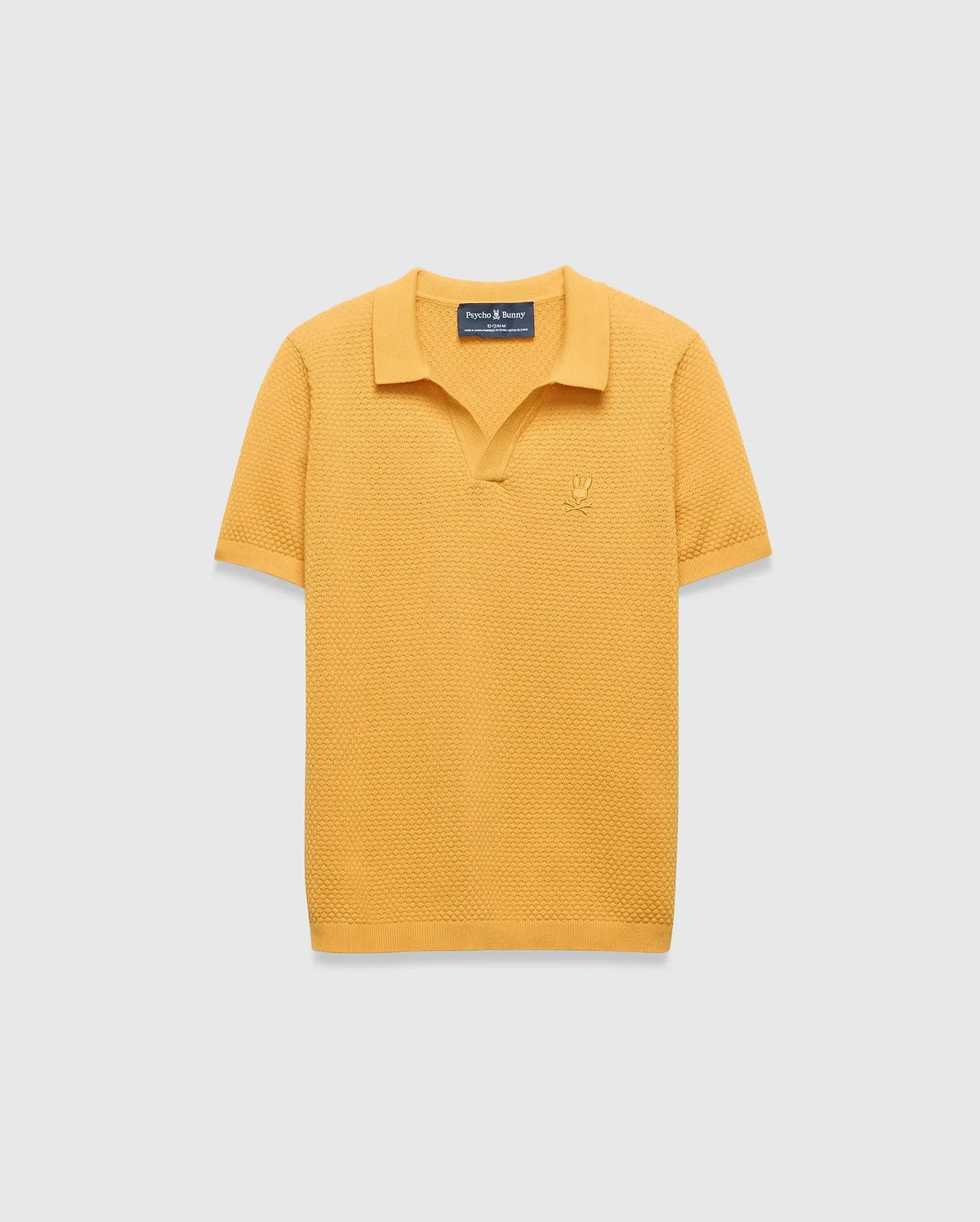 Kids Devon Knit Polo in mustard yellow, featuring a textured knit fabric, classic fit, and a small tonal embroidered Psycho Bunny skull logo on the left chest.