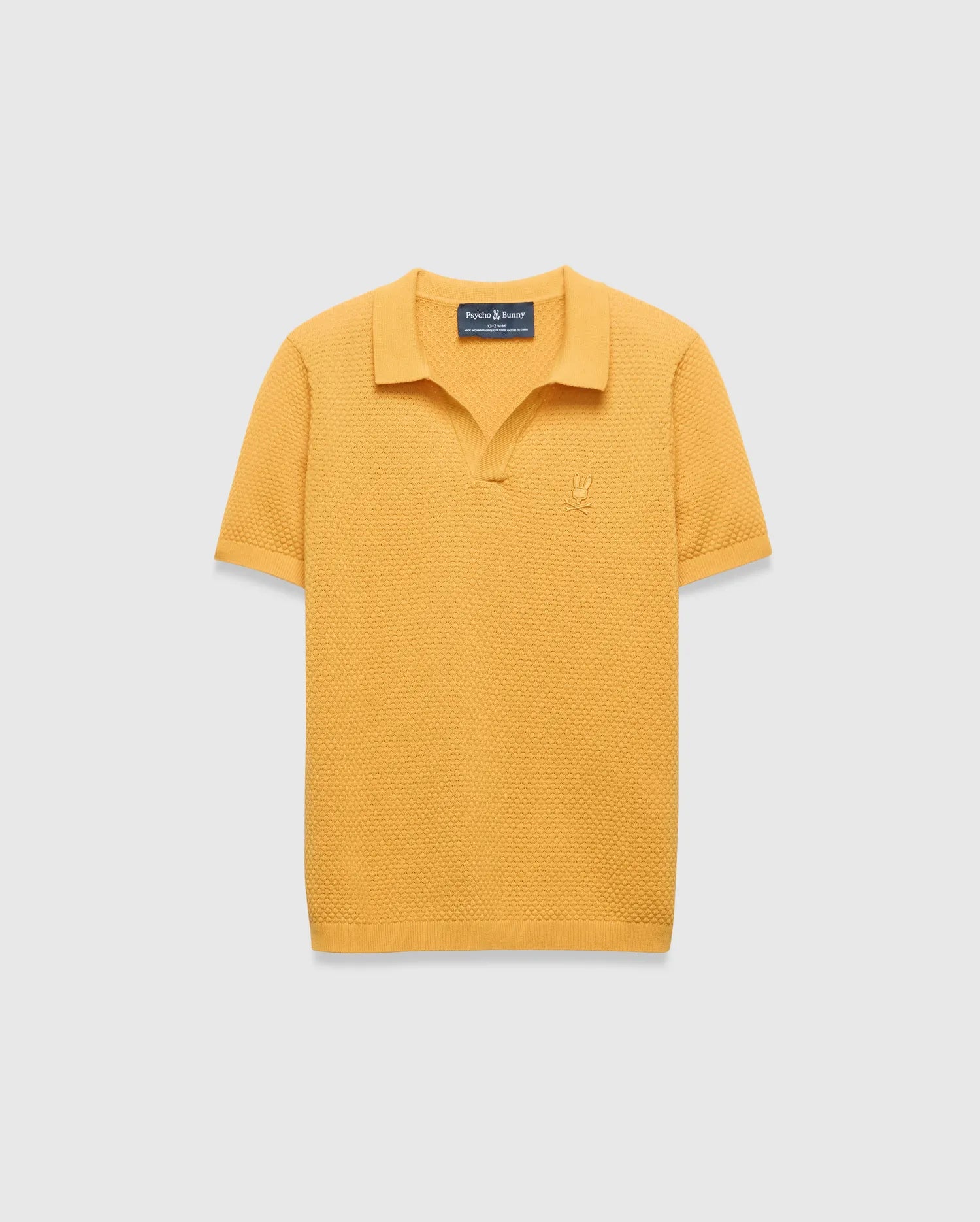 Kids Devon Knit Polo in mustard yellow, featuring a textured knit fabric, classic fit, and a small tonal embroidered Psycho Bunny skull logo on the left chest.
