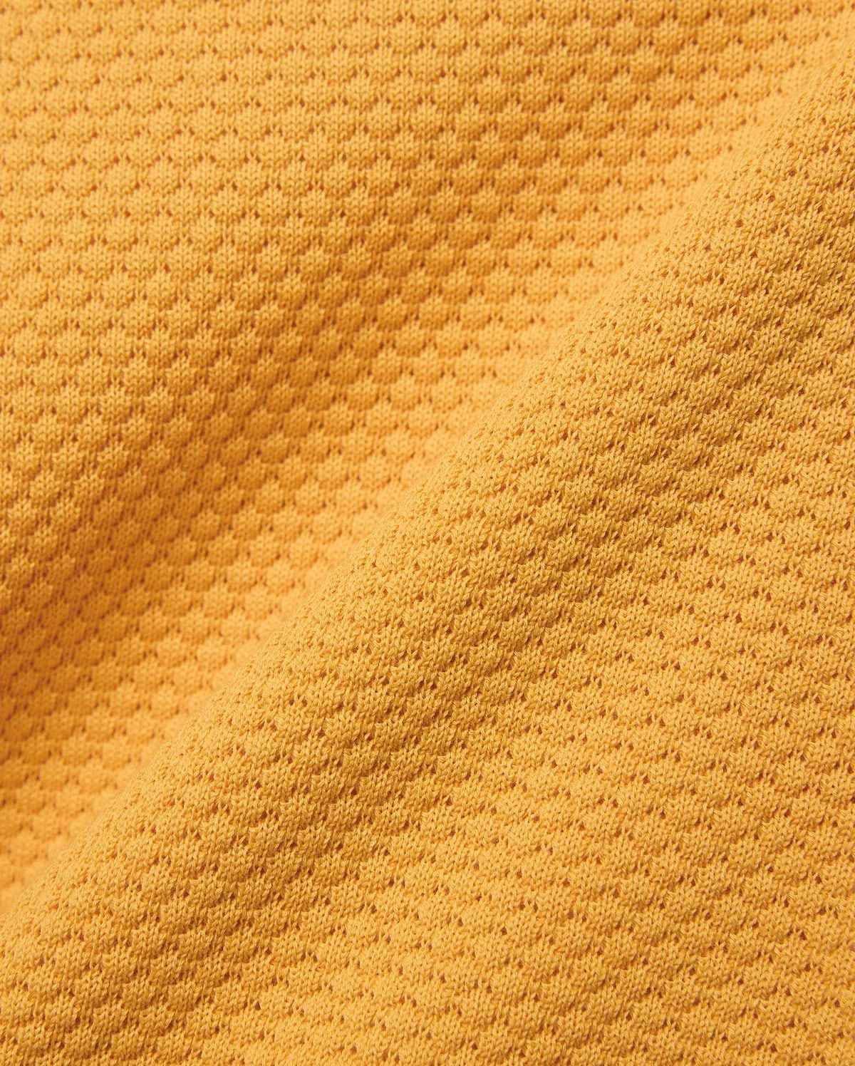 Kids Devon Knit Polo in bold golden-yellow, crafted from a premium, refined knit fabric featuring a distinctive micro-waffle texture, perfect for elevated streetwear style.