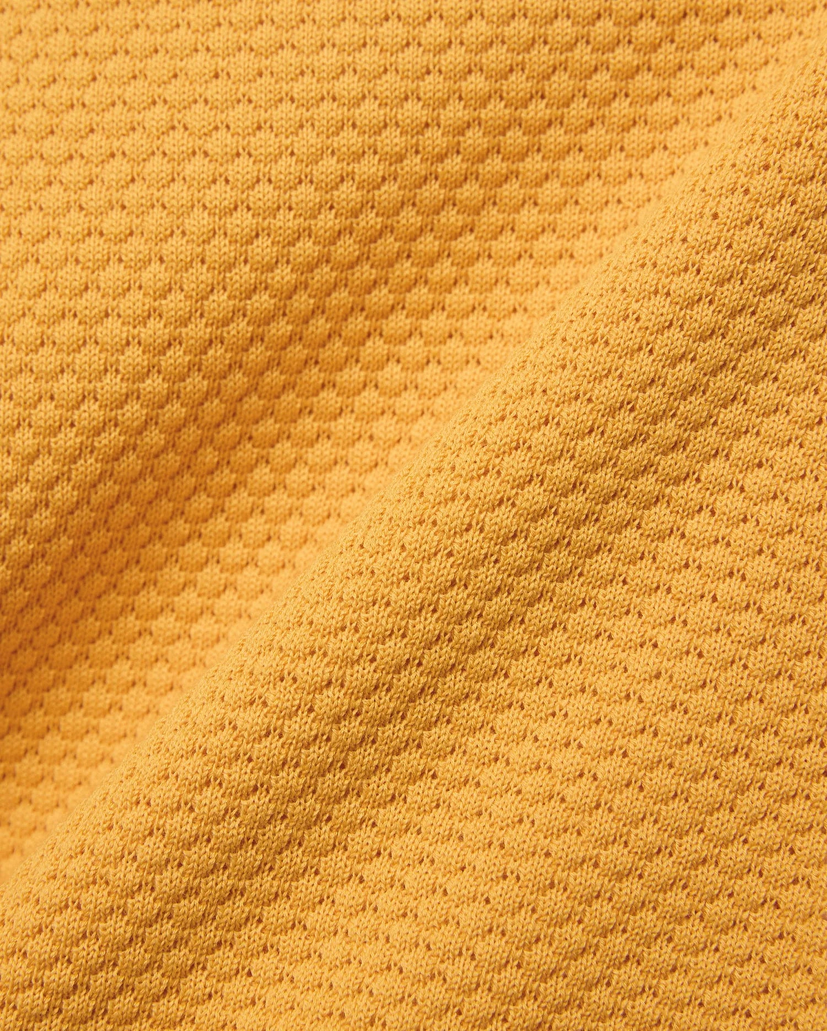 Kids Devon Knit Polo in bold golden-yellow, crafted from a premium, refined knit fabric featuring a distinctive micro-waffle texture, perfect for elevated streetwear style.