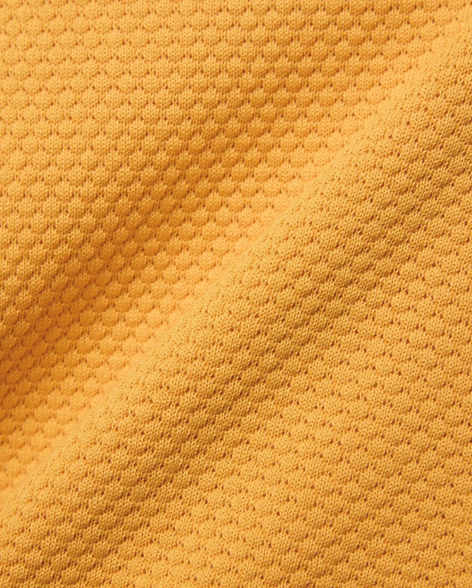 Kids Devon Knit Polo in bold golden-yellow, crafted from a premium, refined knit fabric featuring a distinctive micro-waffle texture, perfect for elevated streetwear style.