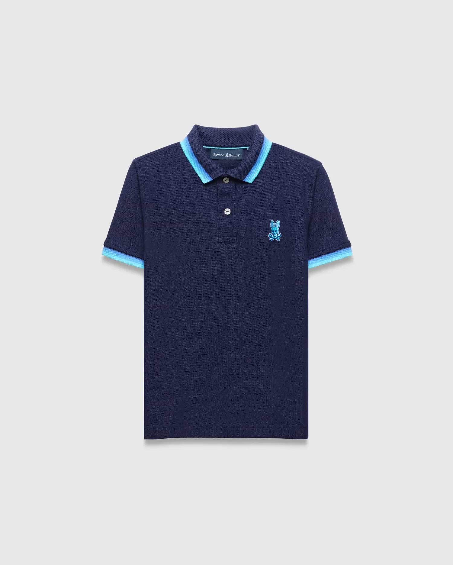 Kids Holden Pique Polo in navy blue, featuring a classic fit, textured pique fabric, a two-button placket, and a light blue double-striped ribbed collar and cuffs, with an embroidered Psycho Bunny skull logo on the left chest. (5)