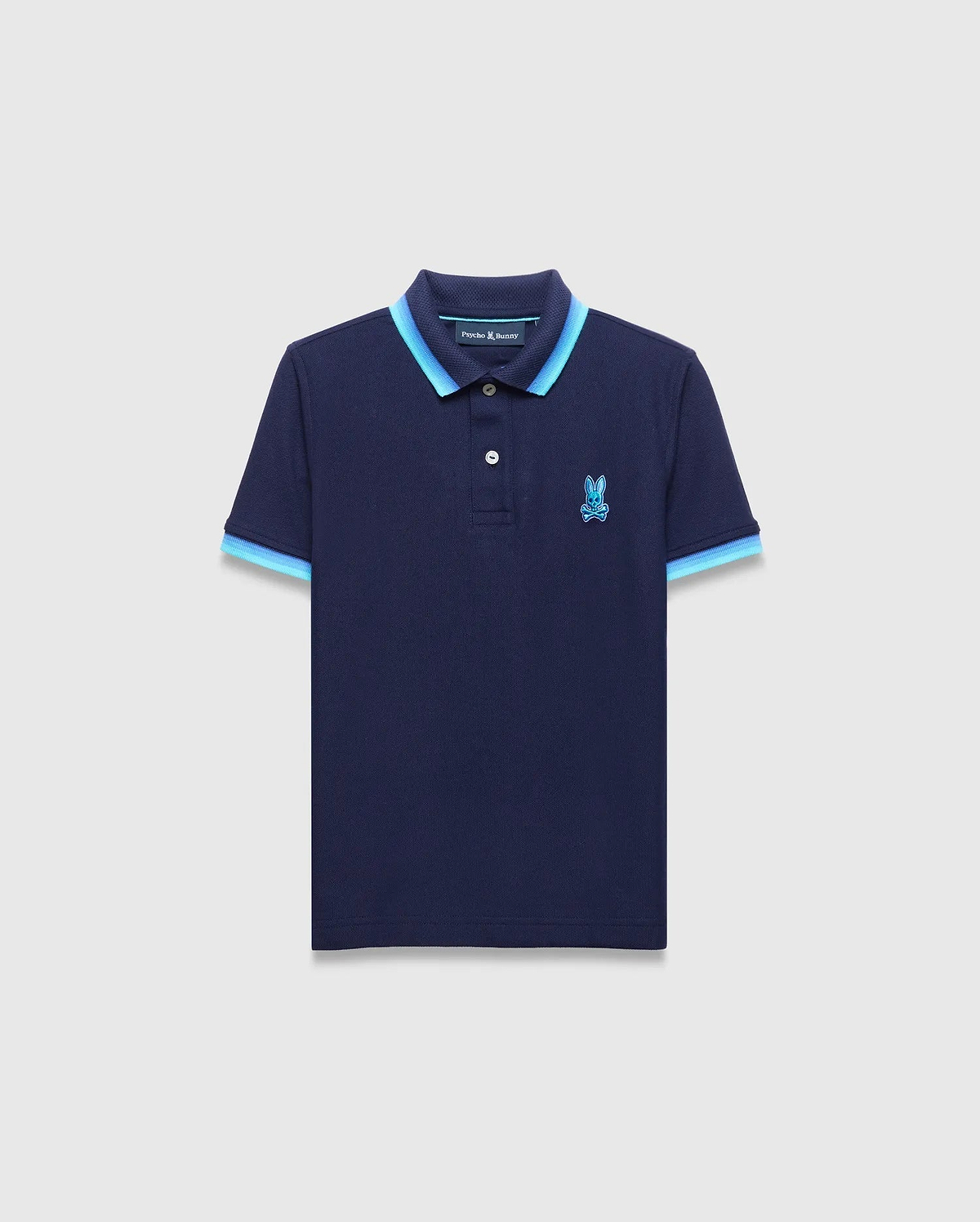Kids Holden Pique Polo in navy blue, featuring a classic fit, textured pique fabric, a two-button placket, and a light blue double-striped ribbed collar and cuffs, with an embroidered Psycho Bunny skull logo on the left chest. (5)