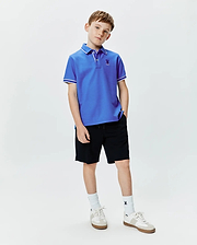 Kids Brad Pique Polo in royal blue, featuring a classic fit, pique knit fabric, white tipping on the collar and sleeve cuffs, and a small embroidered Psycho Bunny skull logo on the left chest.