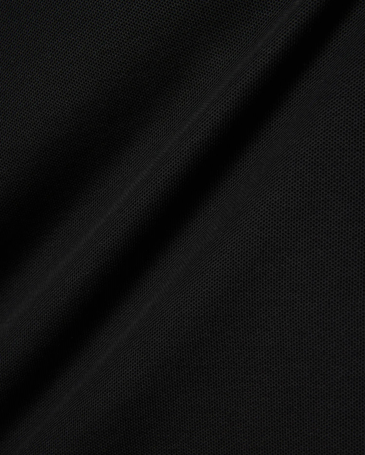 Black Kids Brad Pique Polo fabric, a close-up revealing the refined, breathable textured pique weave with subtle, elegant folds, perfect for premium Psycho Bunny menswear.