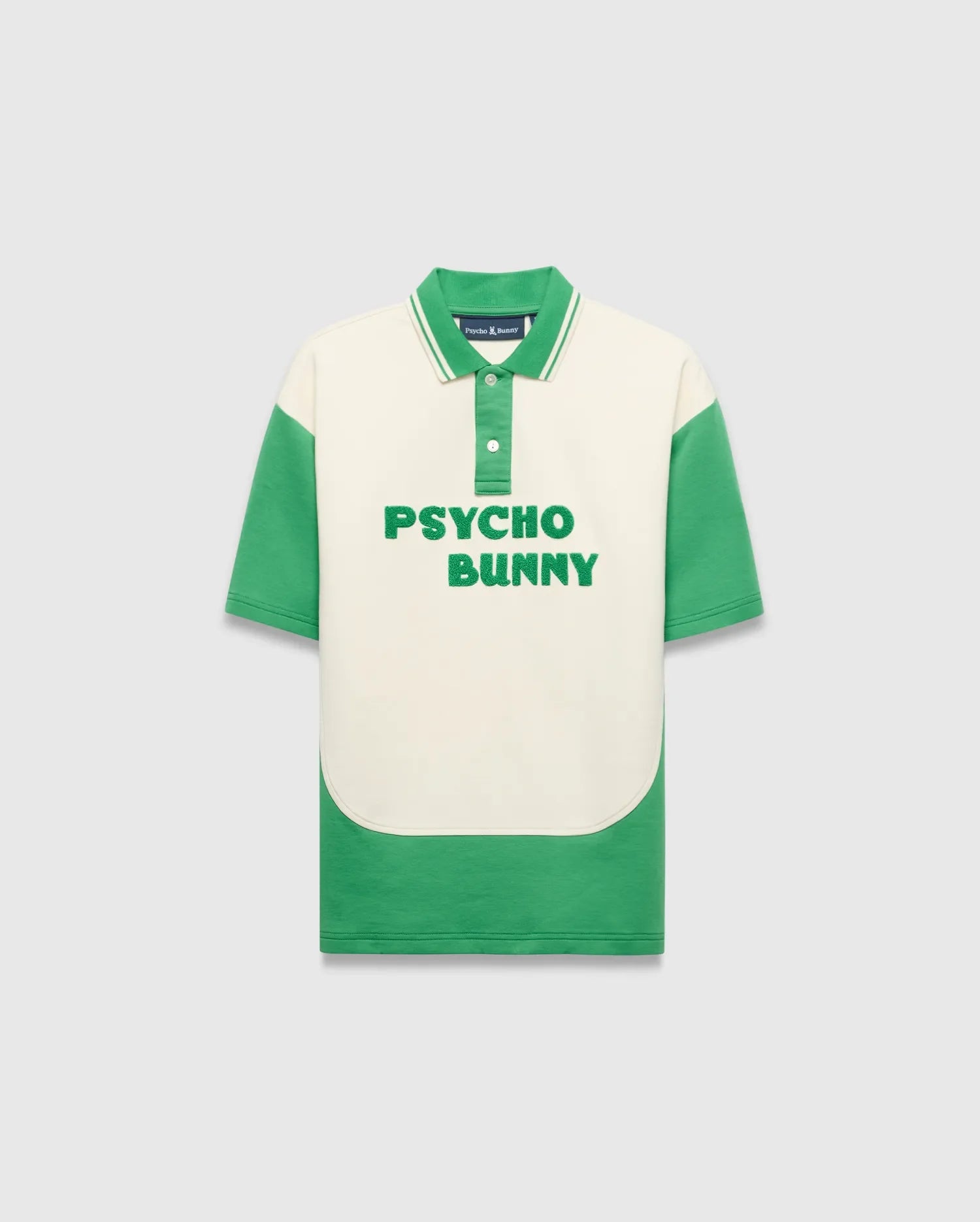 Kids Kelly Oversized Polo, a cream and kelly green color block jersey polo with an oversized fit, featuring large embroidered PSYCHO BUNNY text on the chest and a small embroidered bunny skull logo on the collar.