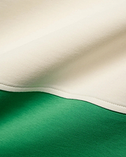 Kids Kelly Oversized Polo in soft jersey knit, featuring a bold color-block design with vibrant kelly green and creamy off-white panels joined by a neat seam.