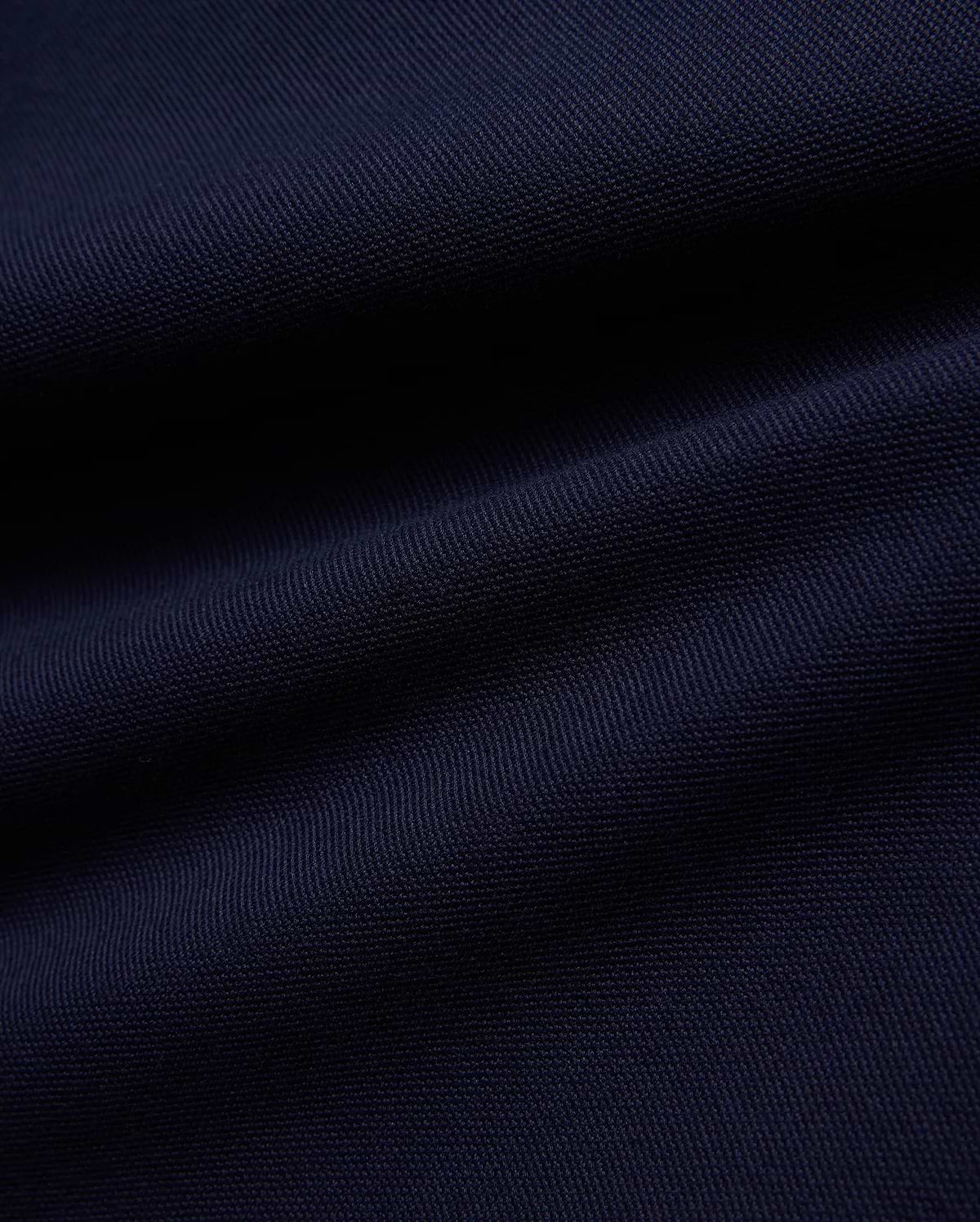 KIDS JAYDON PIQUE POLO in a deep, luxurious navy blue, showcasing the intricate, breathable texture of its premium pique knit fabric, a hallmark of Psycho Bunny's refined quality.