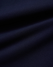KIDS JAYDON PIQUE POLO in a deep, luxurious navy blue, showcasing the intricate, breathable texture of its premium pique knit fabric, a hallmark of Psycho Bunny's refined quality.